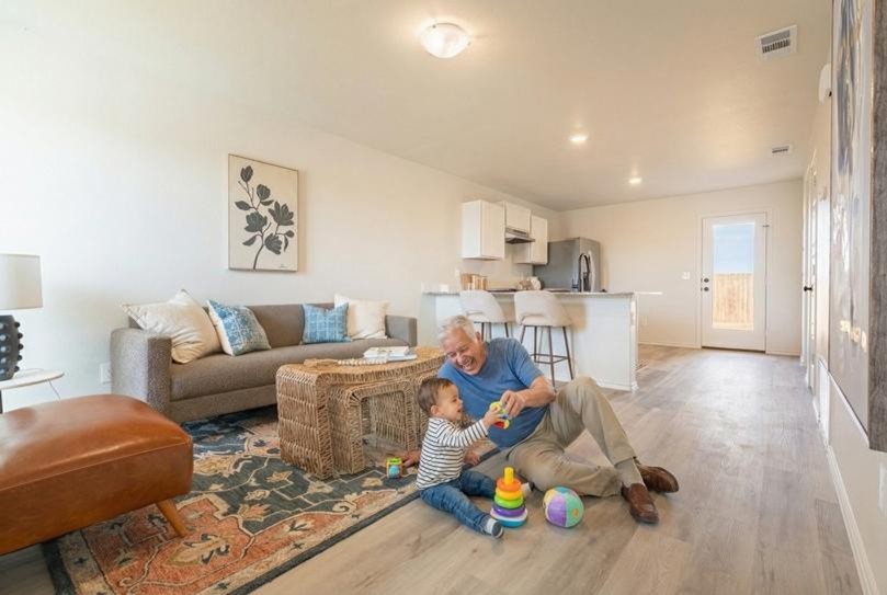 Photo of a man playing with his grandson in his 700-850 sq ft Origin home by Betenbough Homes, West Texas' #1 home builder.