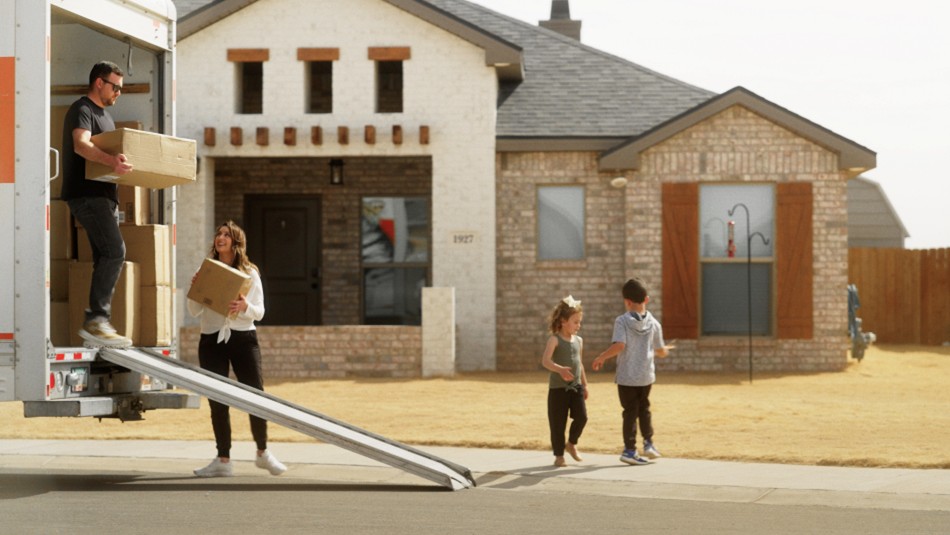 Photo of first-time home buyers moving into their home.