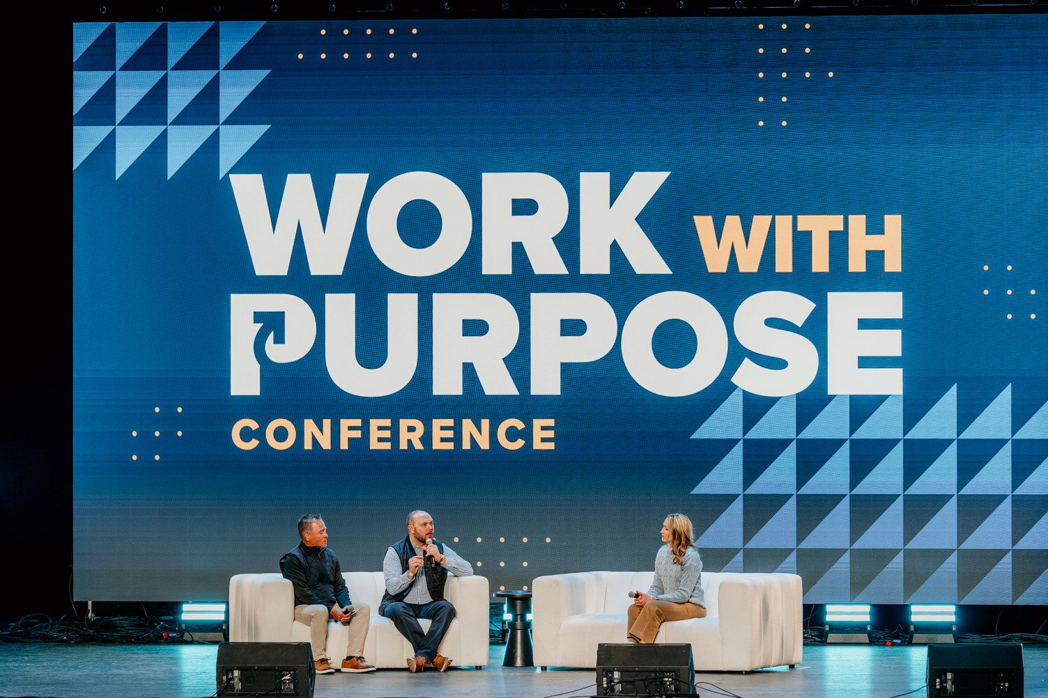Photo of a panel discussion on stage at Kingdom at Work's Work With Purpose Conference.