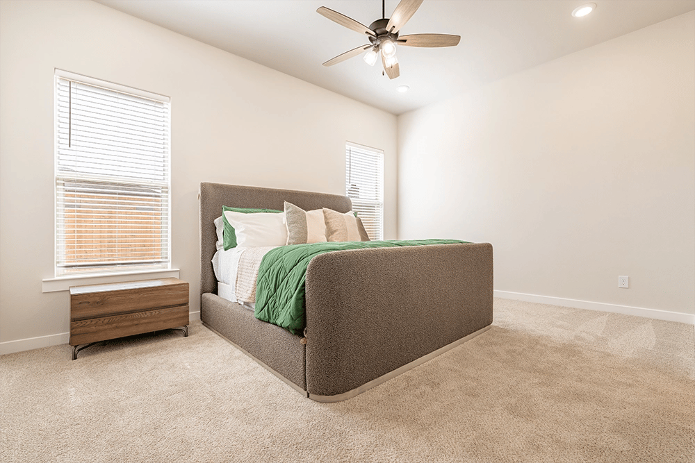 Furnished bedroom in the Nikki, a Betenbough Homes floor plan.
