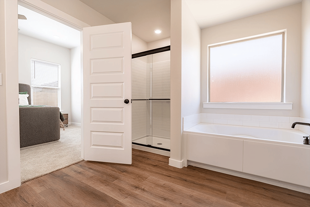 Walk-in shower & garden tub in the Nikki, a Betenbough Homes floor plan.