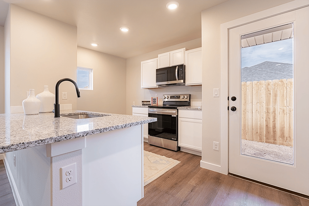 Kitchen & back door in the Priscilla, a Betenbough Homes floor plan.