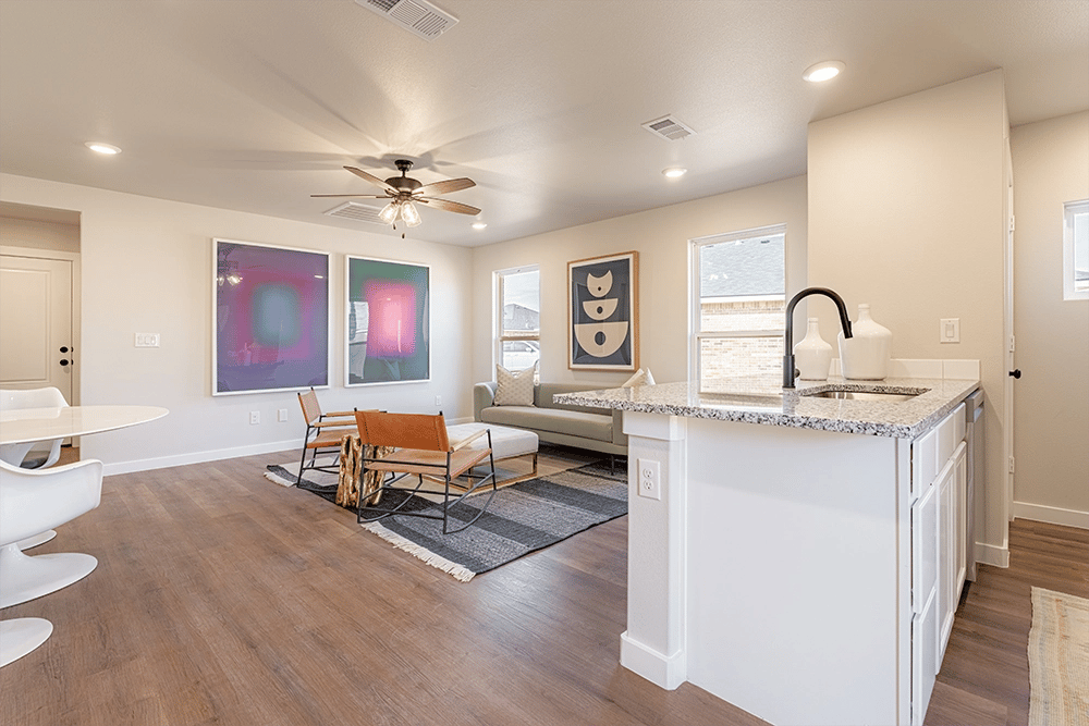Kitchen island & living area in the Priscilla, one of Betenbough's affordable houses for sale.