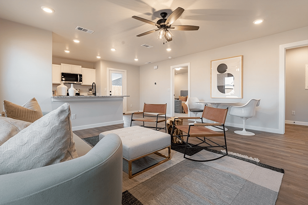 Living area, dining area, & kitchen in the Priscilla, a Betenbough floor plan.