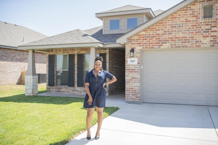 Young woman standing in front of her Betenbough home