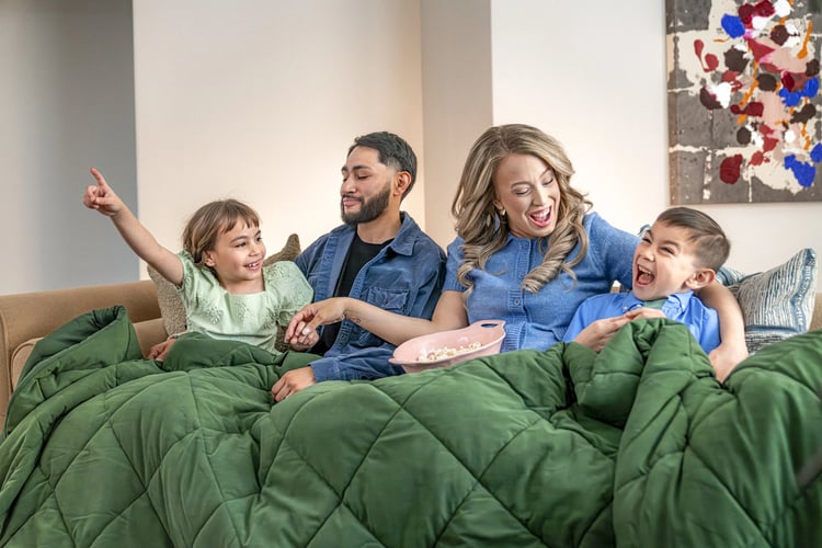 Family sitting on their couch in a Betenbough Home