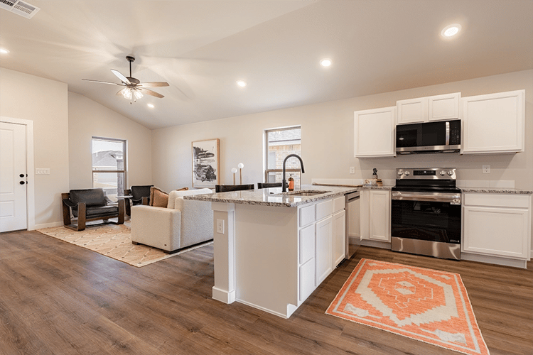 Kitchen & furnished living area in the Giselle, a Betenbough Homes floor plan.
