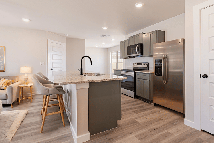 Kitchen with bar seating in the Florence, a floor plan by Betenbough Homes.
