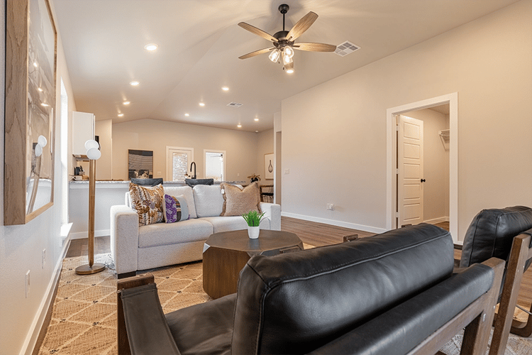 Photo of a furnished living room in the Giselle, one of Betenbough's homes with kitchen peninsula.