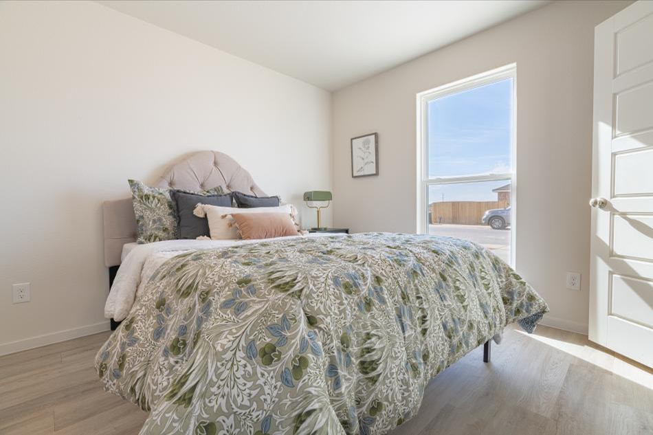 Bedroom Comp Photo of a furnished bedroom in a Betenbough Homes Origin home — floor plans offered to provide everything you need and nothing you don't.