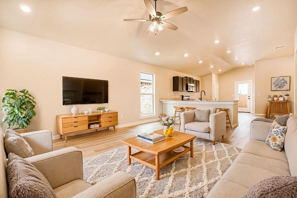 Photo of a furnished living room and kitchen in the Dorris, a 1,550 sq ft Betenbough Homes floor plan.