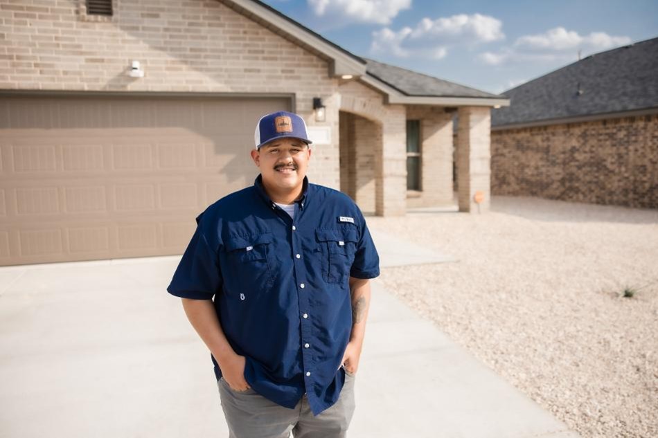 Photo of a homeowner in front of his new Betenbough home.