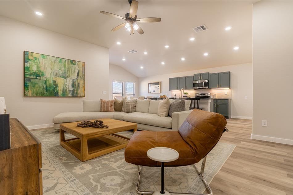 Photo of a furnished living room and kitchen in the Jennifer, a Betenbough Homes floor plan.