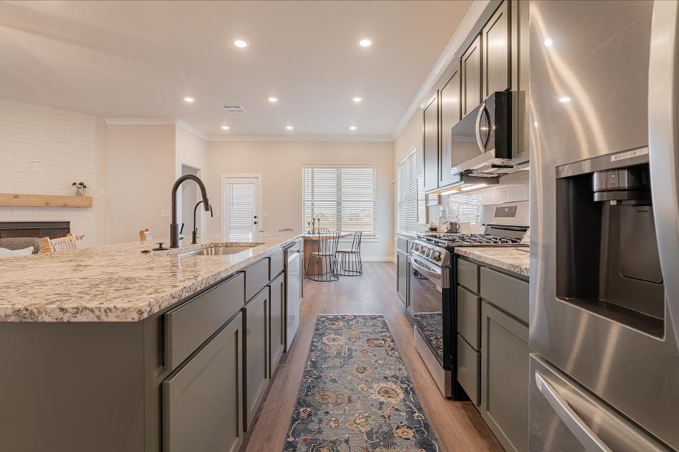 Photo of staged kitchen looking into the dining room in the Layla, Betenbough Homes' 2025 Amarillo parade home.