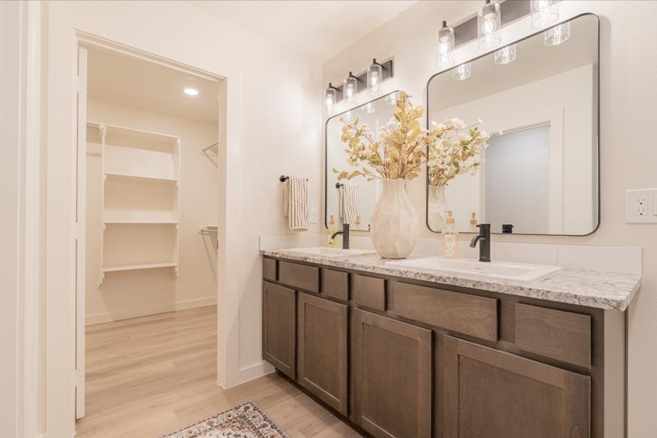 Photo of the double vanities and walk-in closet in the Mia floor plan, a Parade Home by Betenbough Homes Midland.