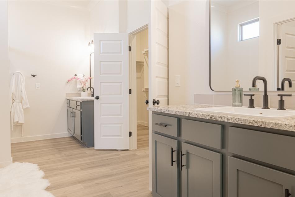 Photo of the two vanities in the 2025 Betenbough Homes Odessa parade home entry's mater bathroom.