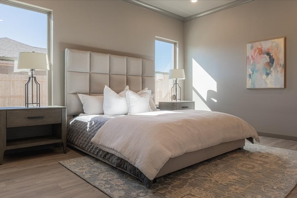 Photo of the staged master bedroom in the 2025 Betenbough Homes Odessa parade home entry.
