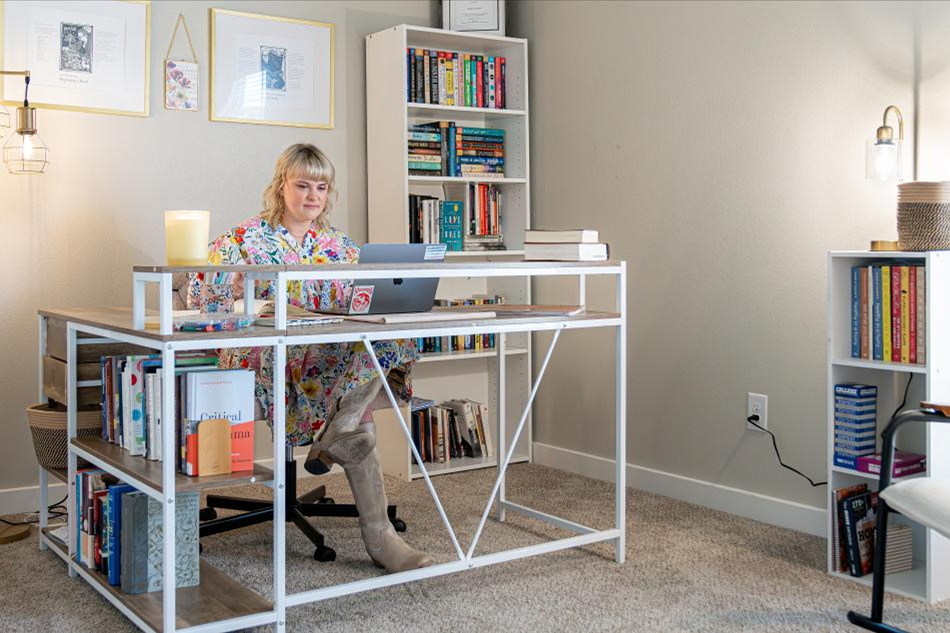 Photo of a woman using a spare bedroom as a home office in her Betenbough home.