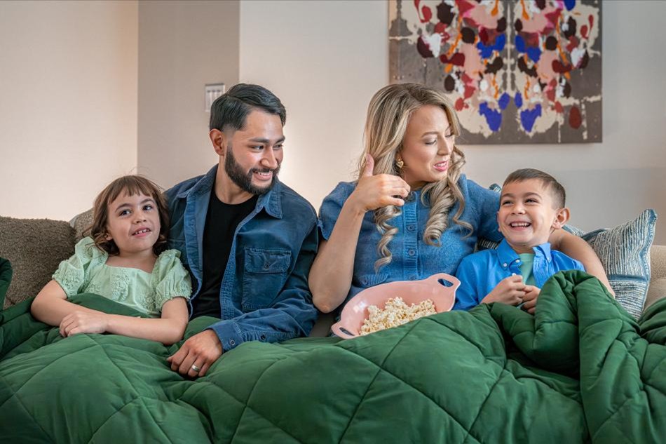 Utilities Comp Photo of a family enjoying a movie night in their new construction home by Betenbough Homes, West Texas' #1 new home builder.