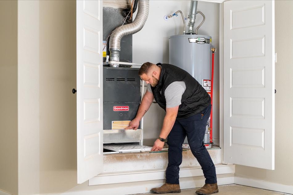 Photo of a Betenbough Homes warranty technician taking care of a warranty call for a homeowner.