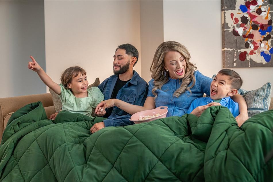 Photo of a family enjoying a movie night in their Betenbough home.