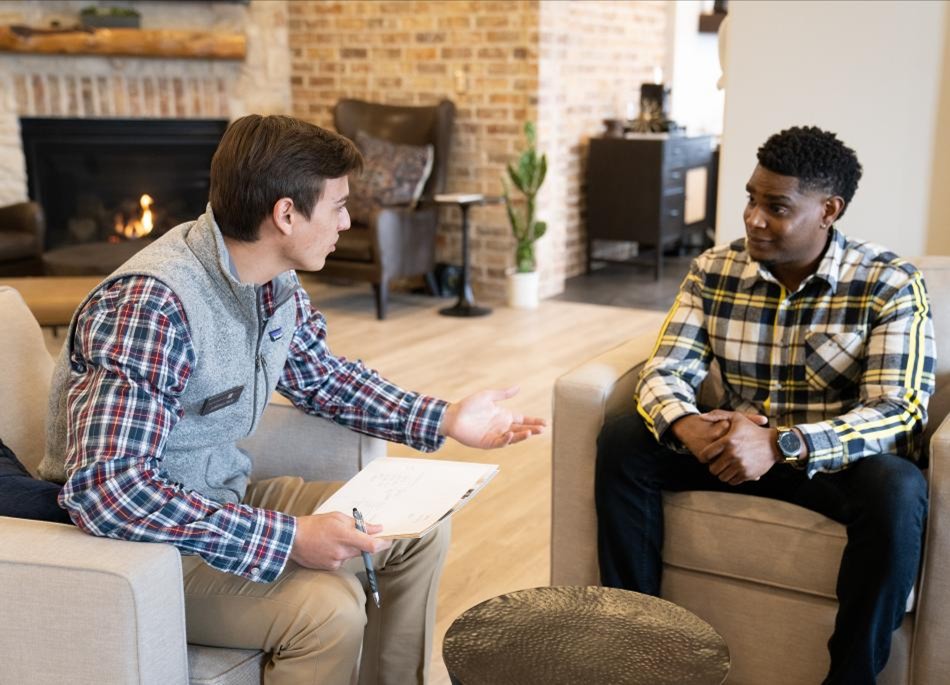 A potential home buyer discusses home ownership with a Betenbough Homes preferred lender.