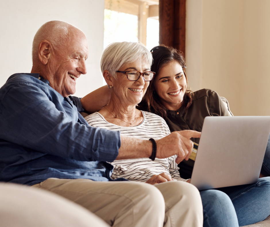 Photo of a woman looking at downsized homes online with her parents.